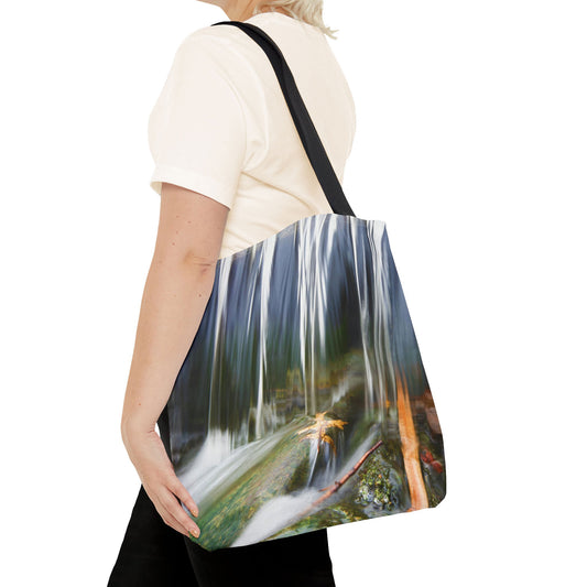 Young woman with a tote bag featuring the creek waterfall design draped across her shoulder.