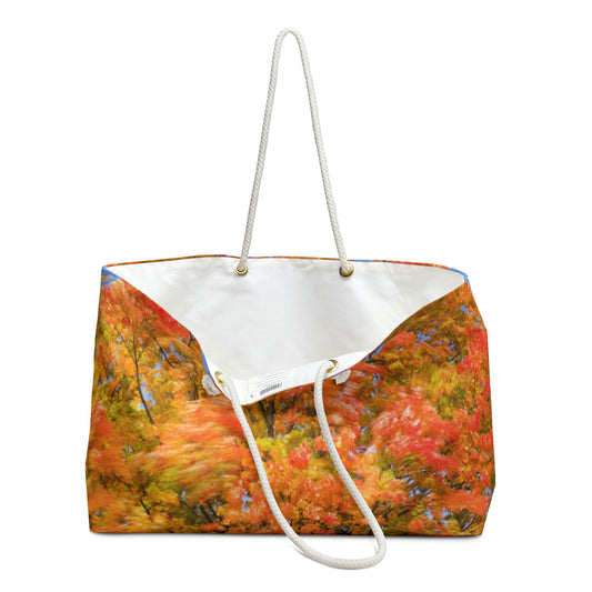 An open view of the beach bag with fall colored trees design shows the cream colored interior lining.