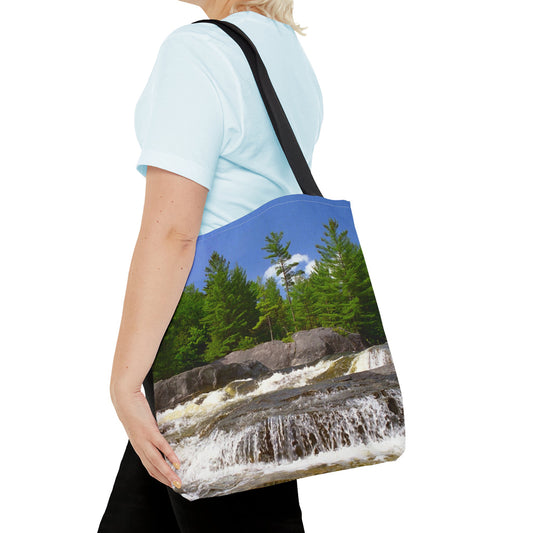 Young woman with a tote bag featuring the forest waterfall design draped across her shoulder.