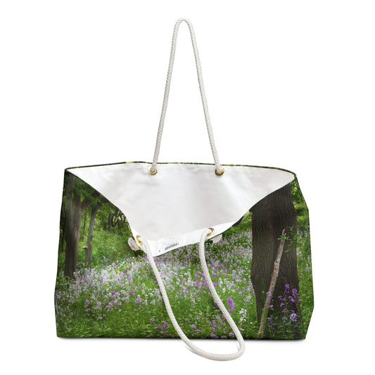 An open view of the beach bag with forest wildflowers design shows the cream colored interior lining.