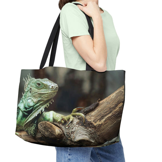 Young woman with a weekender bag featuring the green iguana design hanging from her shoulder.