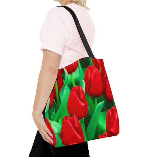 Young woman with a tote bag featuring the red tulips design draped across her shoulder.