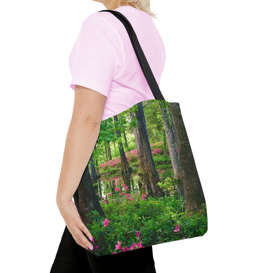 Young woman with a tote bag featuring the wetland design draped across her shoulder.