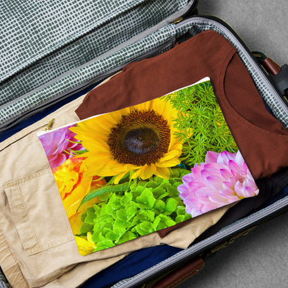 Large pouch with flower bouquet design lying flat atop the contents of an open suitcase.