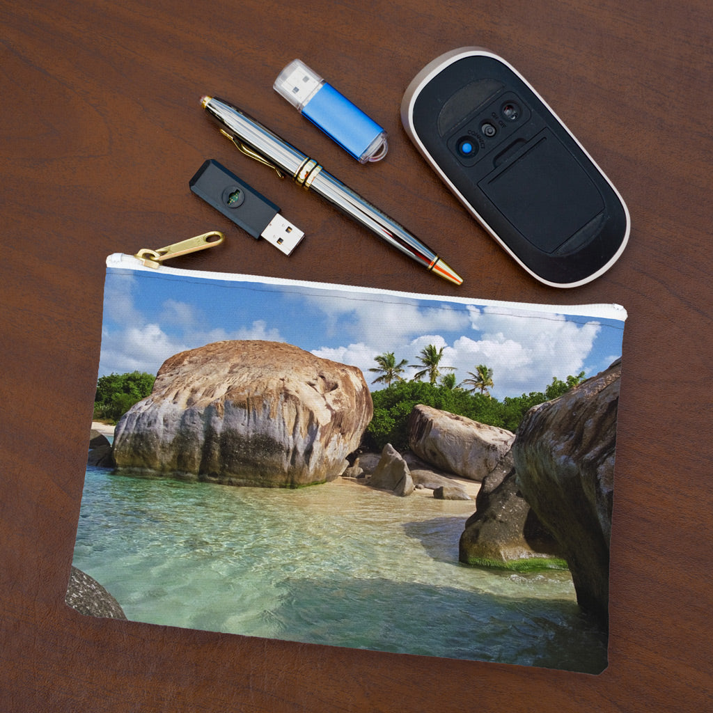 Small pouch with calm turquoise water design lying flat on desktop with thumb drives, computer mouse and pen.