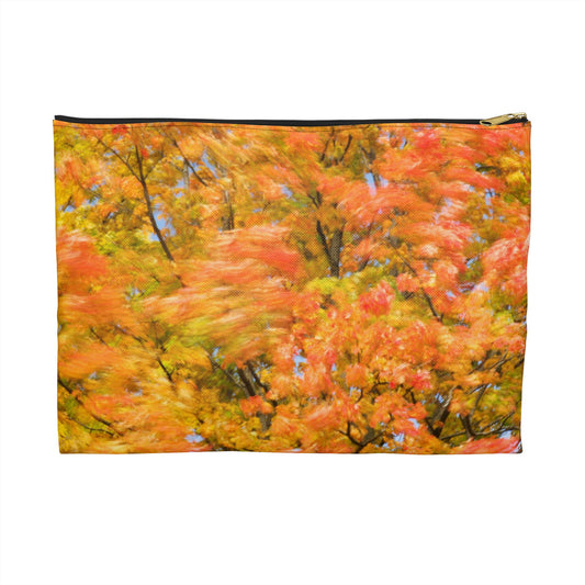 Zippered accessory pouch featuring vibrant photo art of intense fall colored trees swaying wildly in a gusty wind.