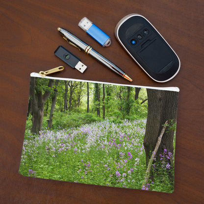 Small pouch with forest wildflowers design lying flat on desktop with thumb drives, computer mouse and pen.