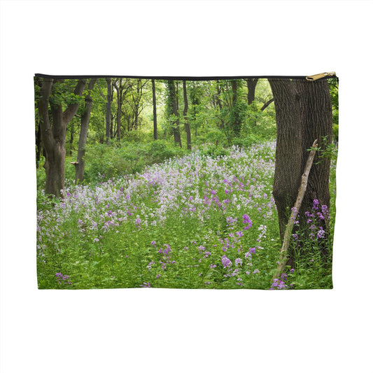 Zippered accessory pouch featuring vibrant photo art of a forest hillside filled with lilac colored wildflowers.