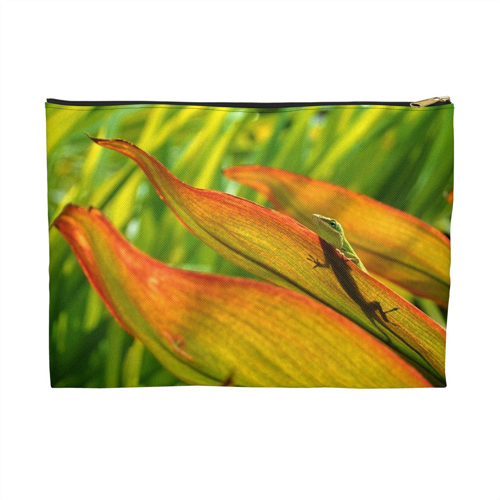 Zippered accessory pouch featuring vibrant photo art of a sunlit green gecko with shadow trying to hide in leaves.