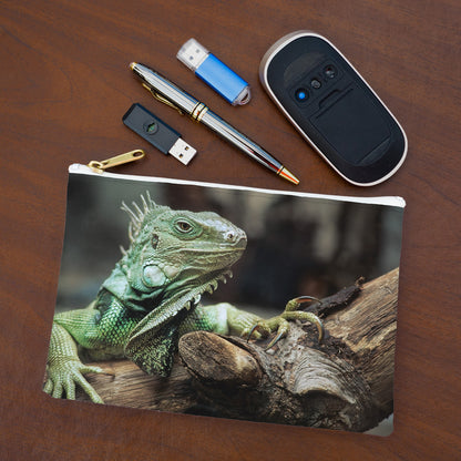 Small pouch with green iguana design lying flat on desktop with thumb drives, computer mouse and pen.