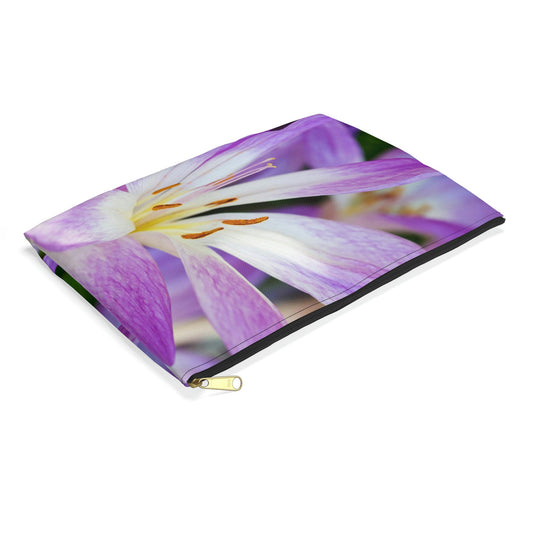 Small pouch with purple flower, orange stamen design lying flat, showcasing the slim profile feature.