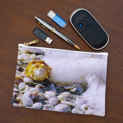 Small pouch with shell in surf design lying flat on desktop with thumb drives, computer mouse and pen.
