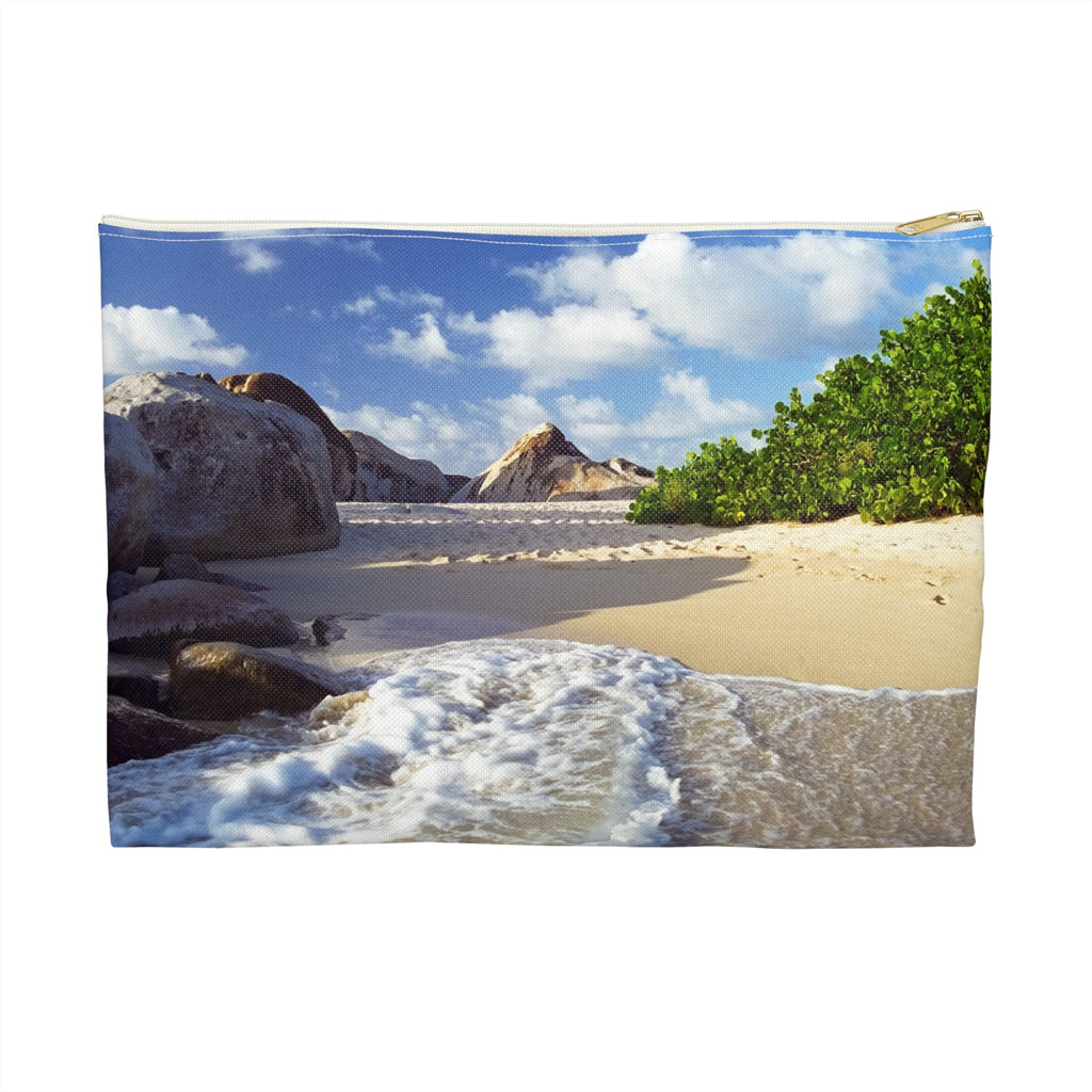 Zippered accessory pouch featuring vibrant photo art of Caribbean beach landscape with surf and huge boulders.