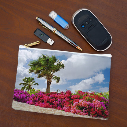 Small pouch with tropical flowers design lying flat on desktop with thumb drives, computer mouse and pen.