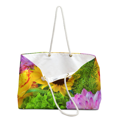 An open view of the beach bag with flower bouquet design shows the cream colored interior lining.