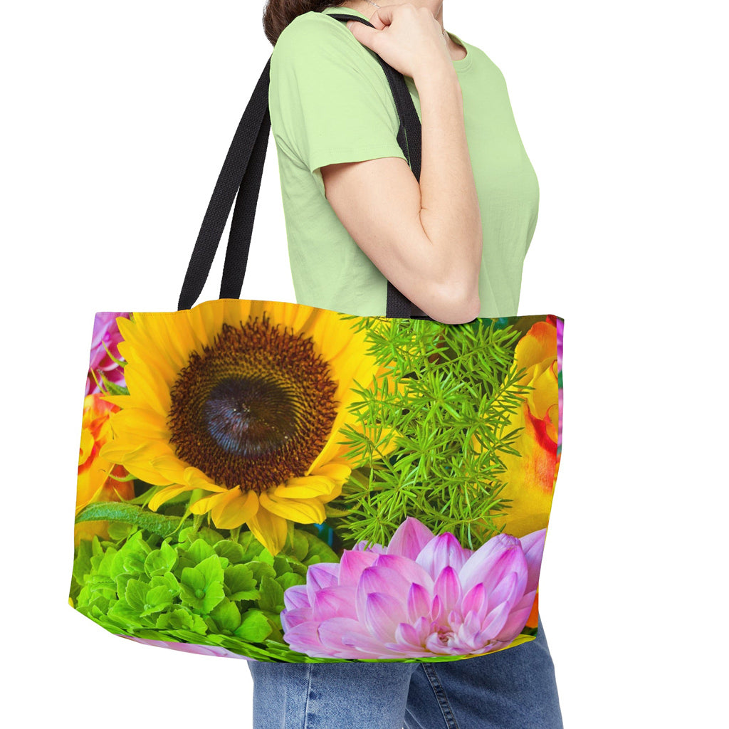 Young woman with a weekender bag featuring the flower bouquet design hanging from her shoulder.