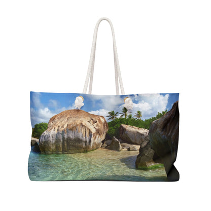 Front view of a beach bag featuring vibrant photo art of Caribbean beach calm turquoise pool sheltered by huge boulders.
