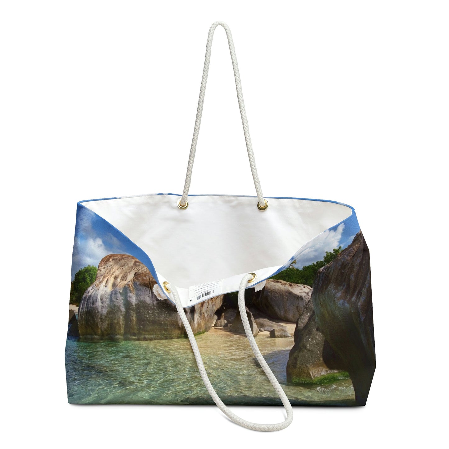 An open view of the beach bag with calm turquoise water design shows the cream colored interior lining.