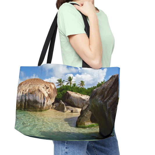Young woman with a weekender bag featuring the calm turquoise water design hanging from her shoulder.