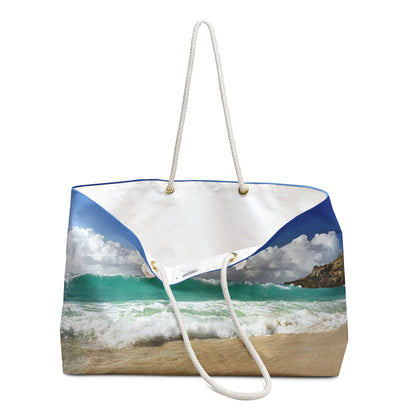 An open view of the beach bag with crashing waves design shows the cream colored interior lining.