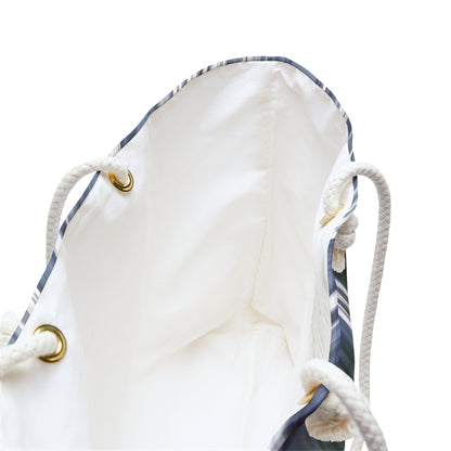 A close up view of the beach bag with creek waterfall design shows the braided rope handles with metal grommets.
