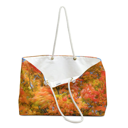 An open view of the beach bag with fall colored trees design shows the cream colored interior lining.