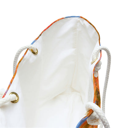 A close up view of the beach bag with fall colored trees design shows the braided rope handles with metal grommets.