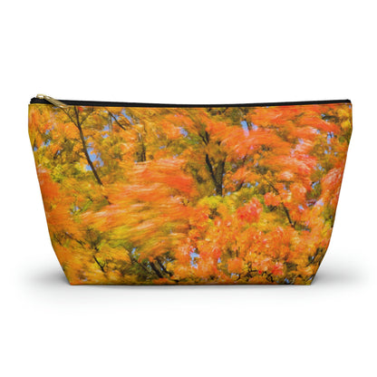 Zippered accessory pouch featuring vibrant photo art of intense fall colored trees swaying wildly in a gusty wind.