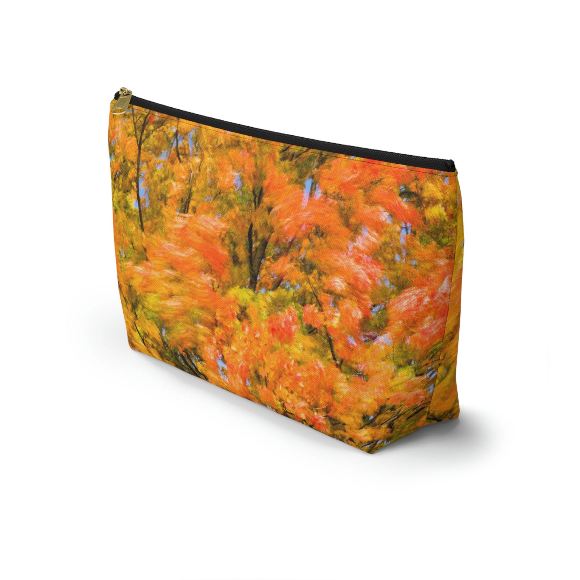Front view of the kit bag with fall colored trees design angled to showcase the depth and all over print design.
