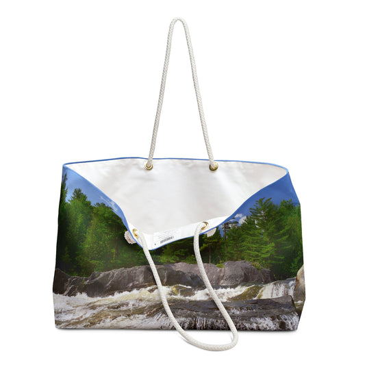 An open view of the beach bag with forest waterfall design shows the cream colored interior lining.