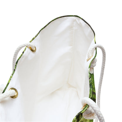 A close up view of the beach bag with forest wildflowers design shows the braided rope handles with metal grommets.
