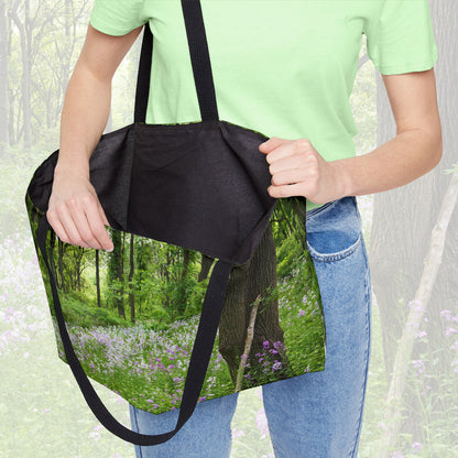 A woman holding open a weekender bag featuring the forest wildflowers design, showcasing the roomy interior.