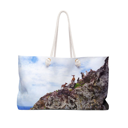 Front view of a beach bag featuring vibrant photo art of goats perched on a rocky cliff staring curiously into camera.