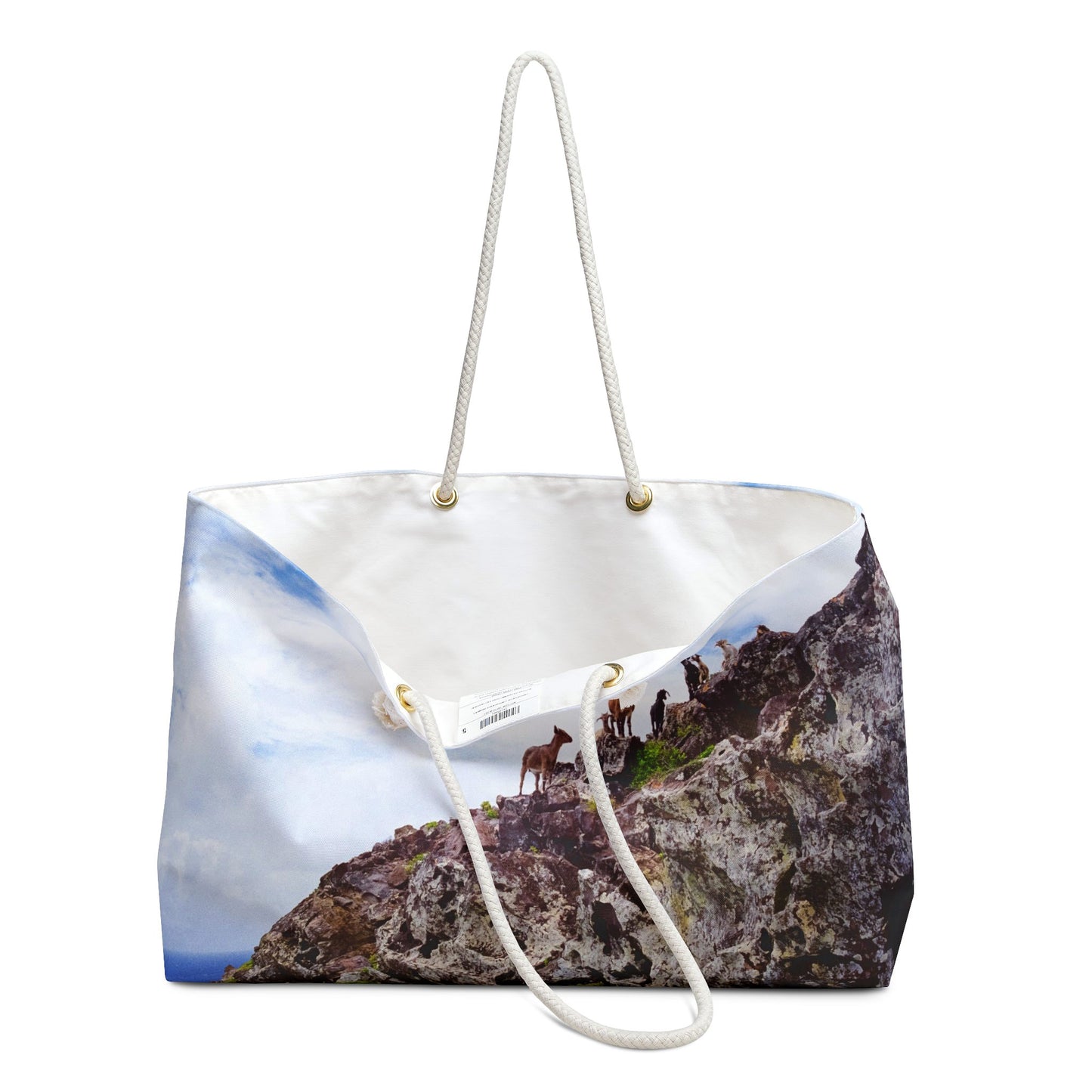 An open view of the beach bag with curious goats design shows the cream colored interior lining.