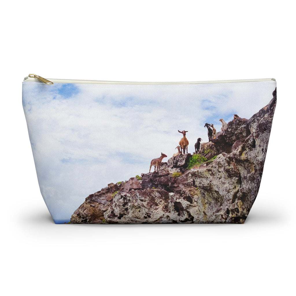 Zippered accessory pouch featuring vibrant photo art of goats perched on a rocky cliff staring curiously into camera. 