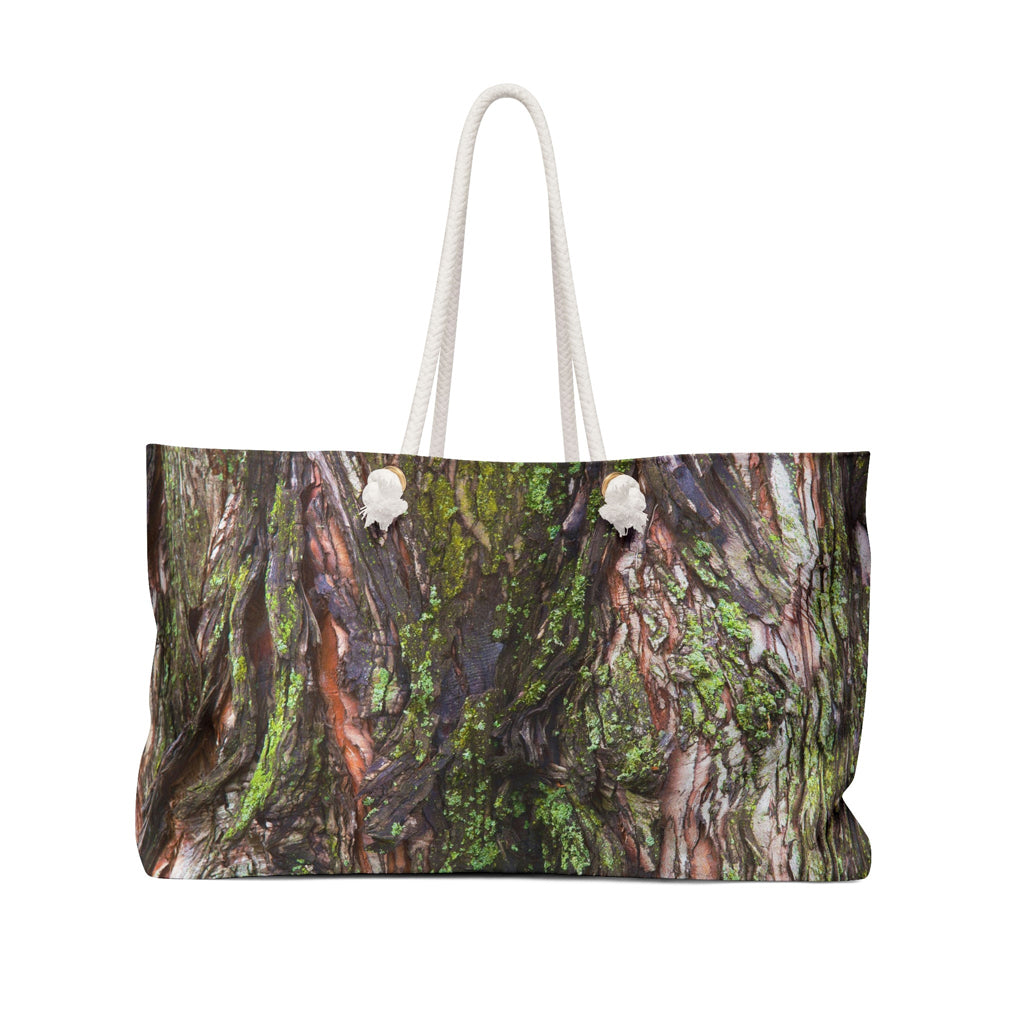 Front view of a beach bag featuring vibrant photo art of brilliant green moss on orange and dark brown tree bark.