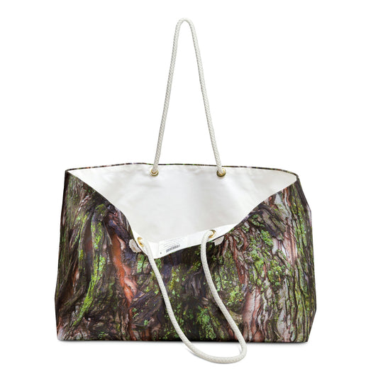 An open view of the beach bag with green mossy bark design shows the cream colored interior lining.