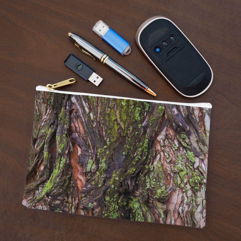 Small pouch with green mossy bark design lying flat on desktop with thumb drives, computer mouse and pen.