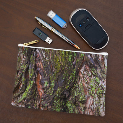 Small pouch with green mossy bark design lying flat on desktop with thumb drives, computer mouse and pen.