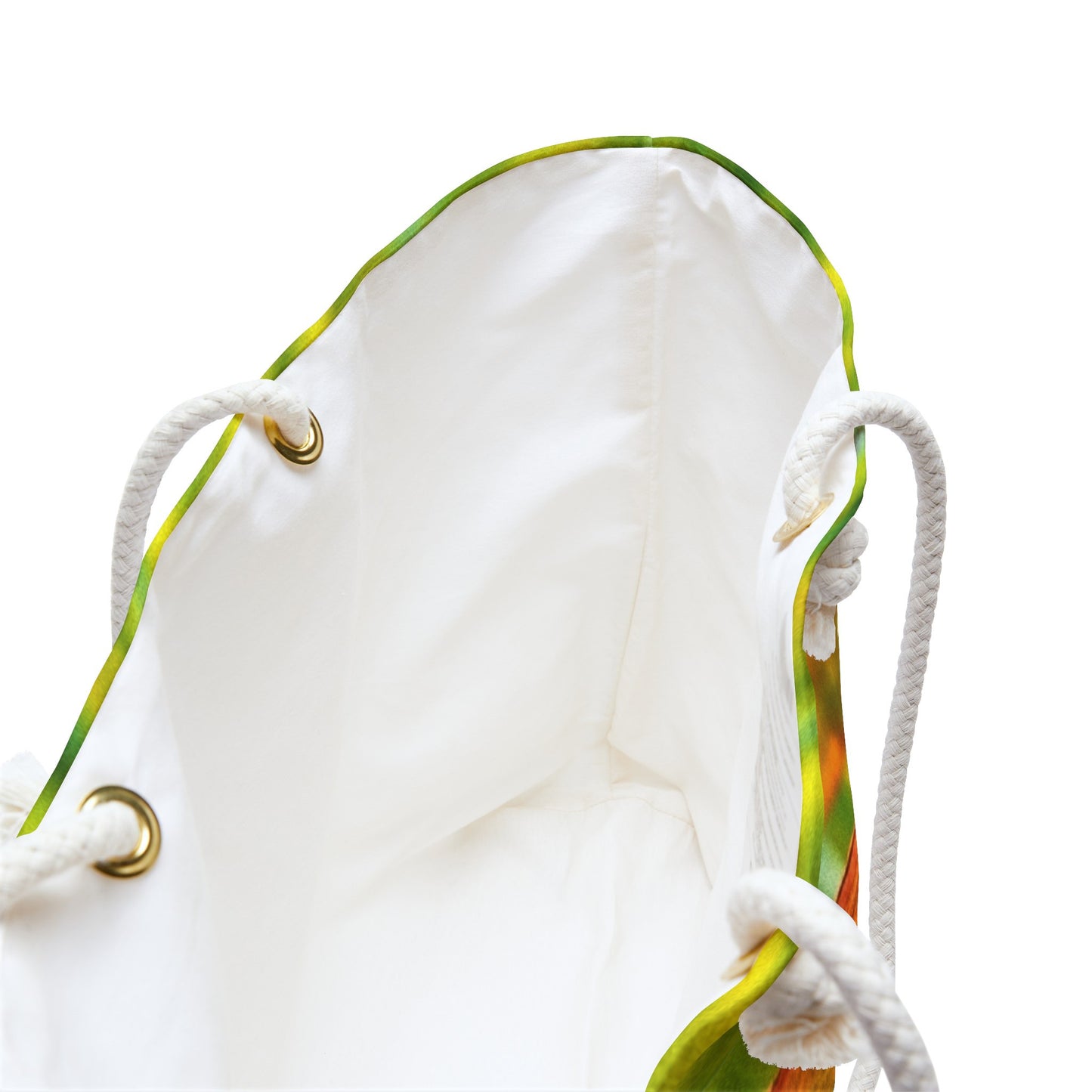 A close up view of the beach bag with sunlit gecko design shows the braided rope handles with metal grommets.