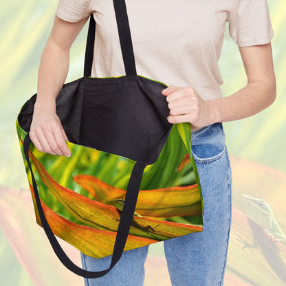 A woman holding open a weekender bag featuring the sunlit gecko design, showcasing the roomy interior.