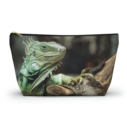 Zippered accessory pouch featuring vibrant photo art close up of a regal looking green iguana perched on a thick branch.