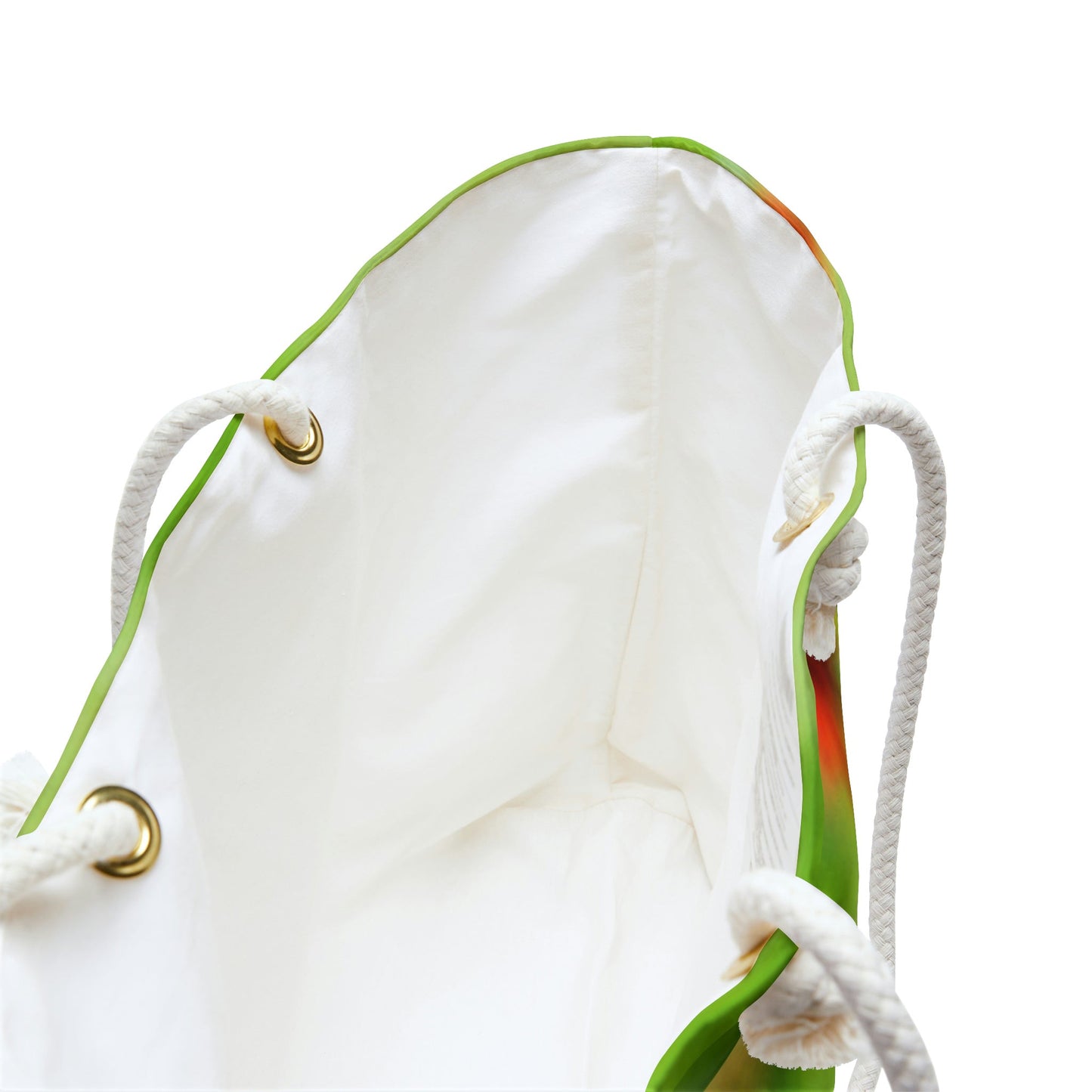 A close up view of the beach bag with butterfly on flower design shows the braided rope handles with metal grommets.
