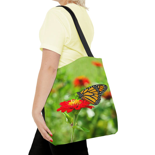 Young woman with a tote bag featuring the butterfly on flower design draped across her shoulder.