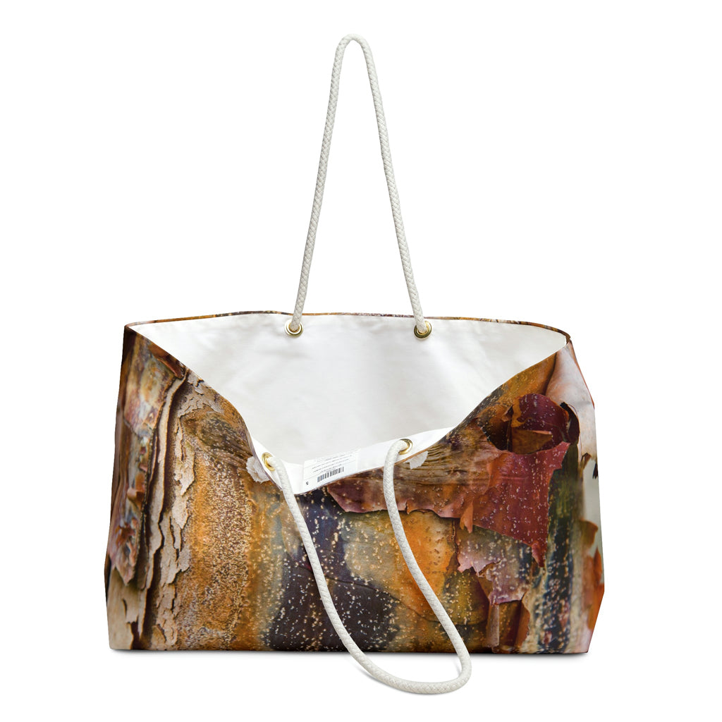 An open view of the beach bag with orange bark design shows the cream colored interior lining.