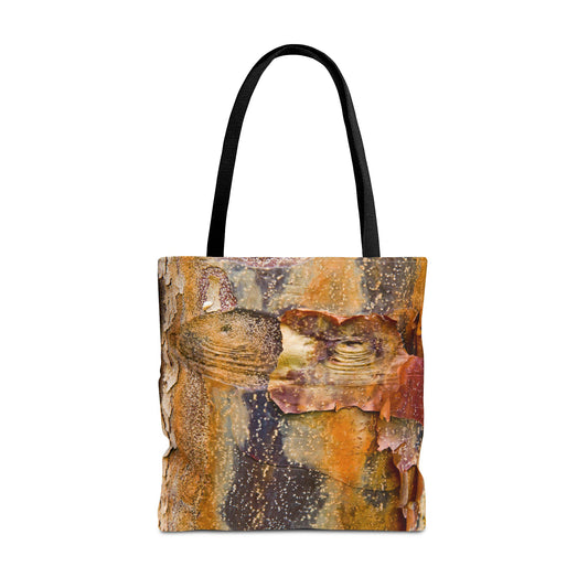 Large 18 x18 inch tote bag featuring vibrant photo art of orange tree bark with eyes and sly smile facial features.