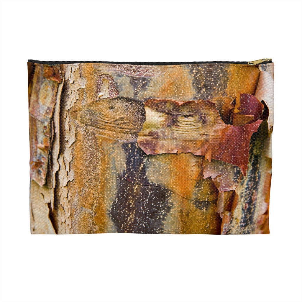 Zippered accessory pouch featuring vibrant photo art of orange tree bark with eyes and sly smile facial features.
