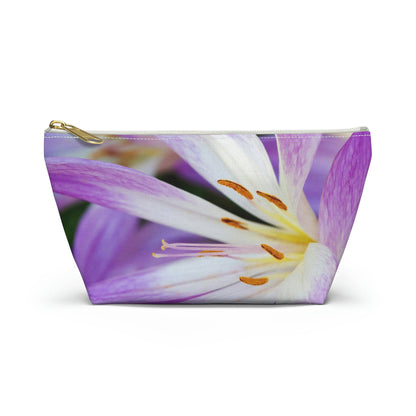 Front view of the small 8.75 x 4.75 x 2.25 inch kit bag with purple flower, orange stamen design and white zipper.