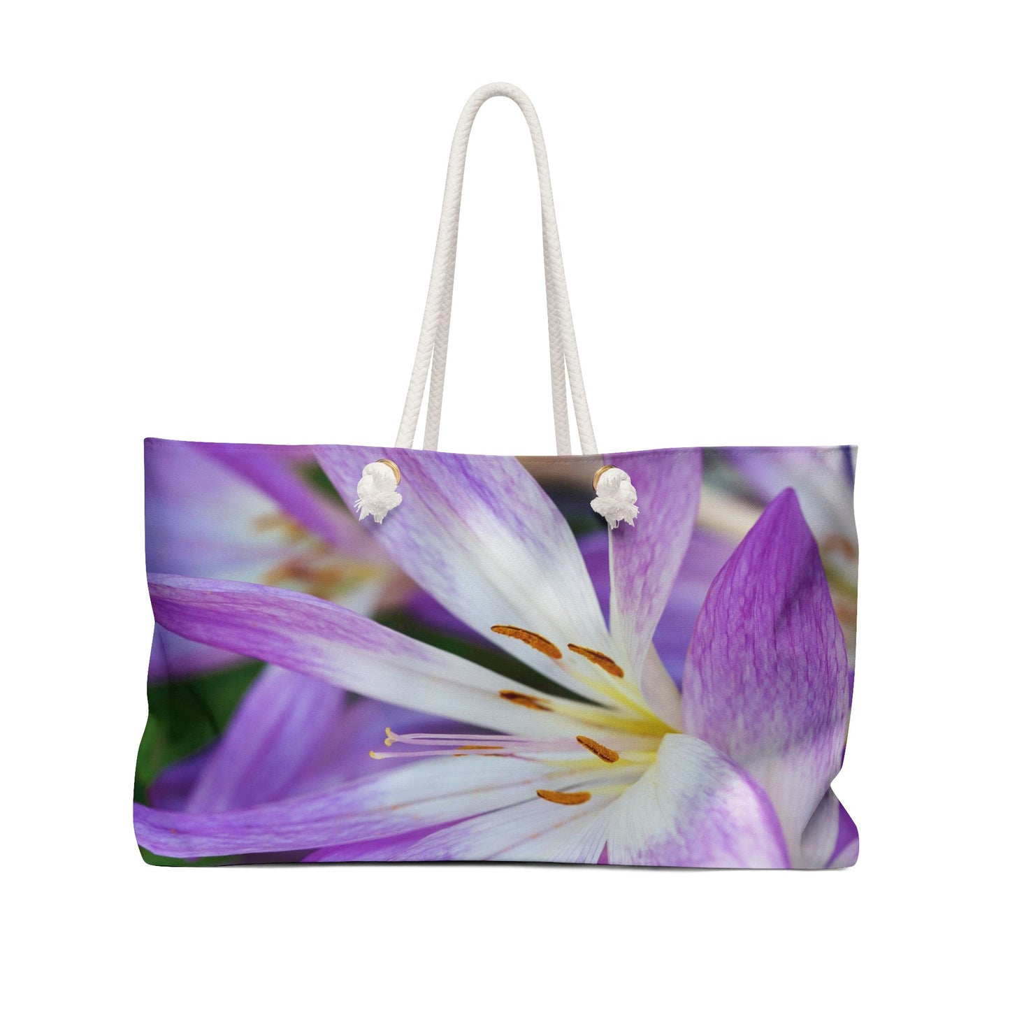 Front view of a beach bag featuring vibrant photo art close up of purple and white flower petals with orange stamen.