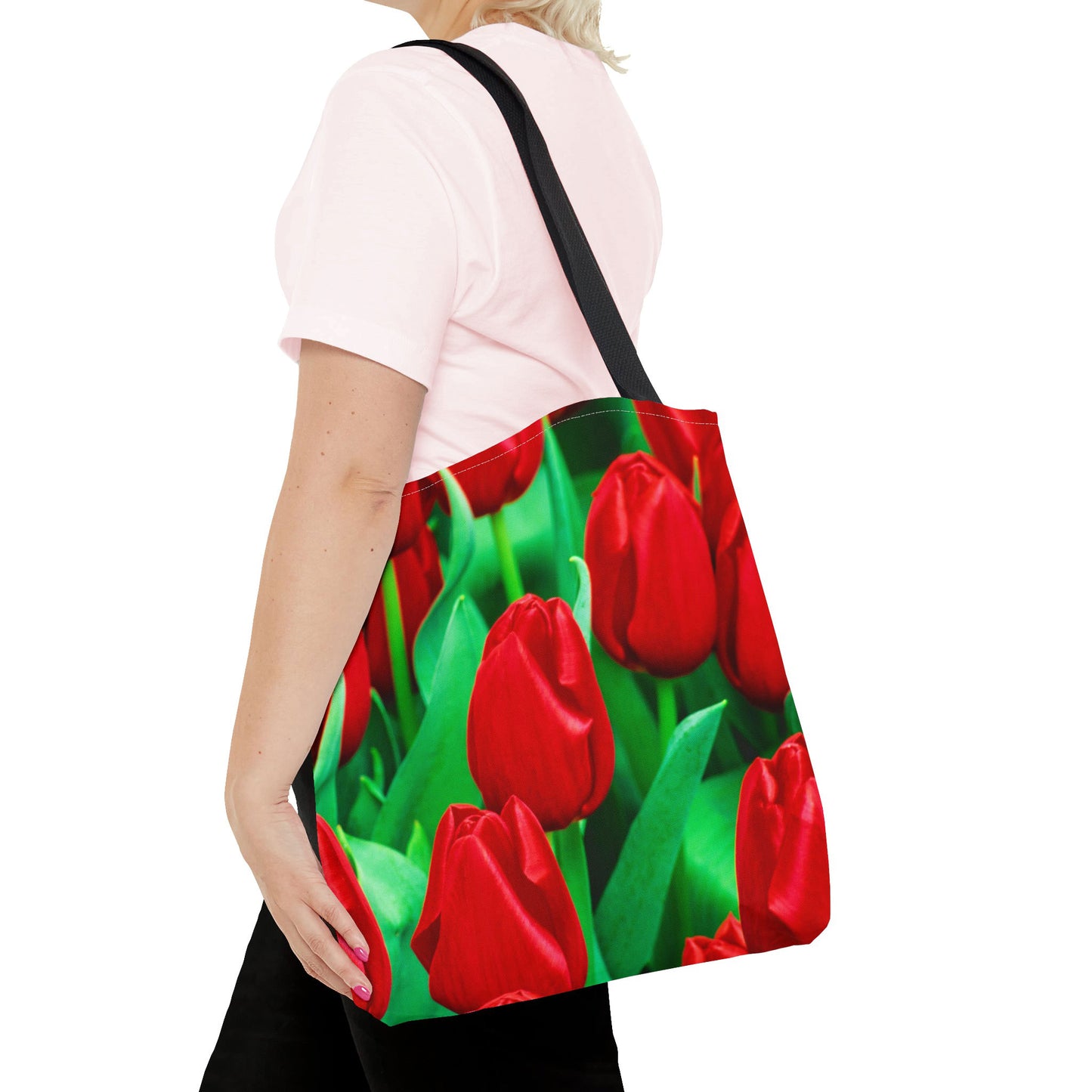 Young woman with a tote bag featuring the red tulips design draped across her shoulder.